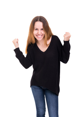 Studio shot: Happy woman with raised armsの写真素材