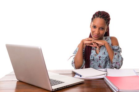 Young african student working with her laptop, isolated over a white backgroundの写真素材