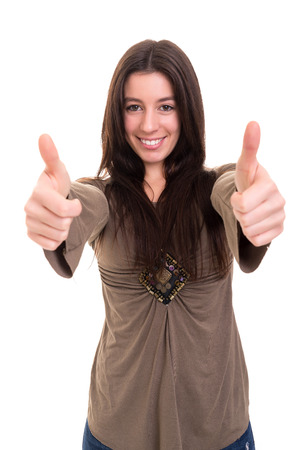 Beautiful young woman signaling ok, isolated over whiteの写真素材