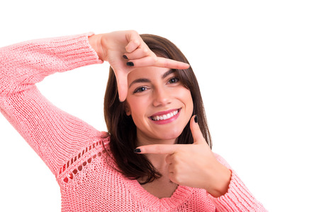 Young woman making framing key gesture - isolated over whiteの写真素材