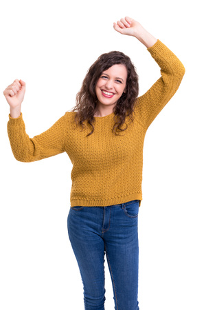 Studio shot: Happy woman with raised armsの写真素材