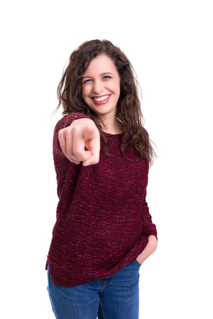 Young beautiful woman pointing at you, isolated over whiteの写真素材