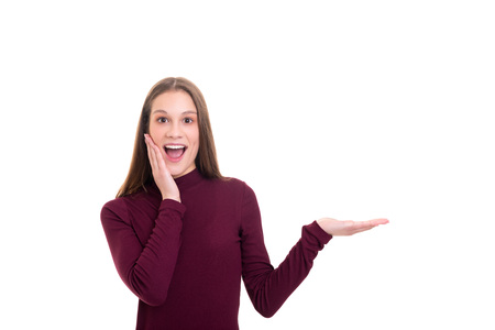Young beautiful woman presenting your product, isolated over white backgroundの写真素材
