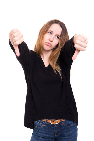 Studio shot of a young woman signaling thumbs downの写真素材