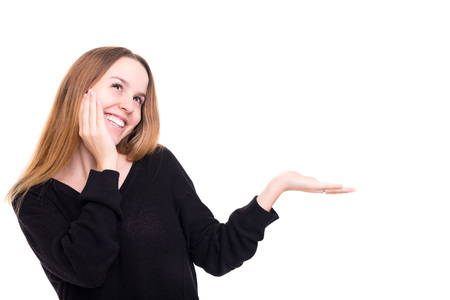 Young beautiful woman presenting your product, isolated over white backgroundの写真素材