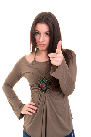 Young beautiful woman pointing at you, isolated over whiteの写真素材