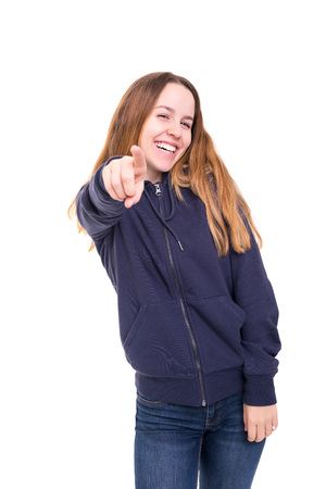 Young beautiful woman pointing at you, isolated over whiteの写真素材
