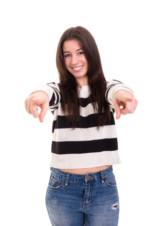 Young beautiful woman pointing at you, isolated over whiteの写真素材