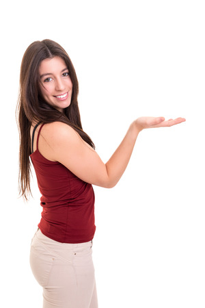 Young beautiful woman presenting your product, isolated over white backgroundの写真素材