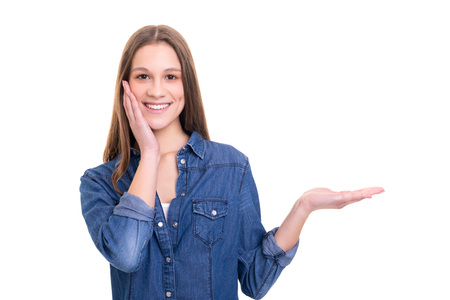 Young beautiful woman presenting your product, isolated over white backgroundの写真素材