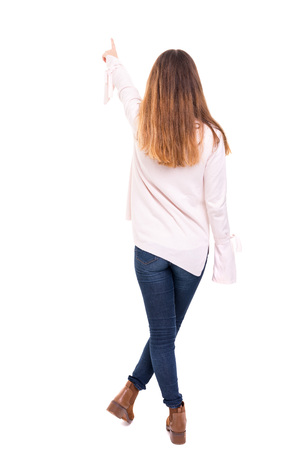 Woman posing with her back faced to camera, isolated over copy space backgroundの写真素材