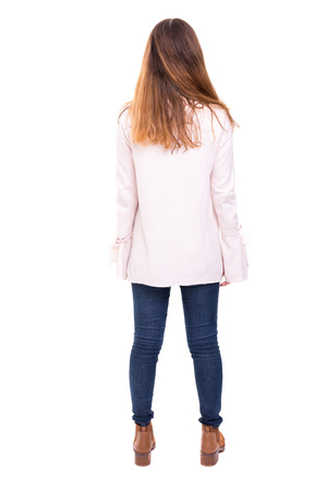 Woman posing with her back faced to camera, isolated over copy space backgroundの写真素材