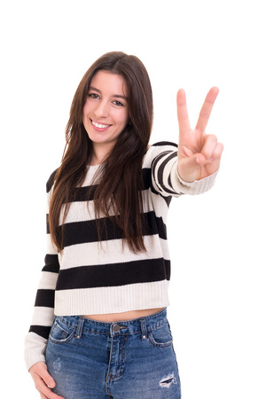 Beautiful young woman signaling ok, isolated over whiteの写真素材