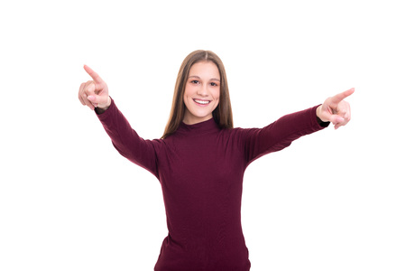 Young beautiful woman pointing at you, isolated over whiteの写真素材