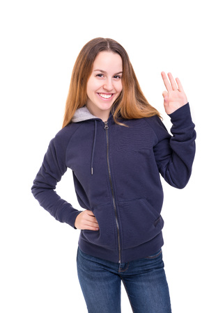 Beautiful young woman signaling ok, isolated over whiteの写真素材