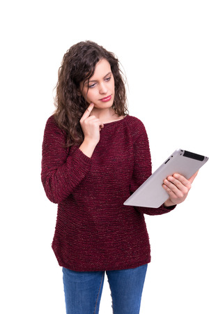 Beautiful woman working with a new tablet computer, isolated over white backgroundの写真素材