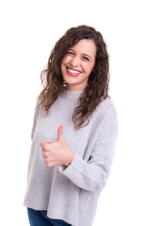 Beautiful young woman signaling ok, isolated over whiteの写真素材
