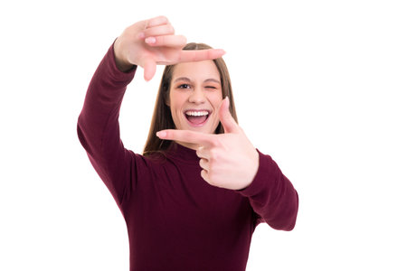 Young woman making framing key gesture - isolated over whiteの写真素材