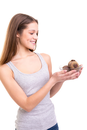 Beautiful blonde woman holding some fresh beets, isolated over white backgroundの写真素材