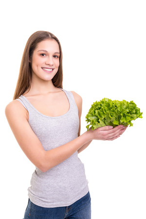 Young woman holding a fresh lettuce, isolated over white backgroundの写真素材