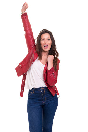 Studio shot: Happy woman with raised armsの写真素材