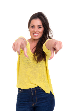 Young beautiful woman pointing at you, isolated over whiteの写真素材