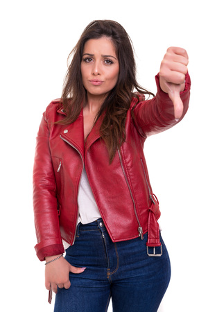 Studio shot of a young woman signaling thumbs downの写真素材