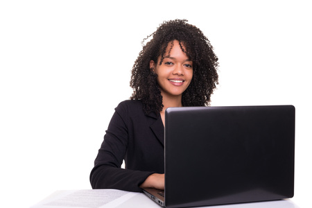 Young african business woman working with a laptop pc, isolated over whiteの写真素材