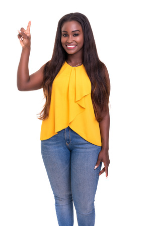 A beautiful african woman pointing to something, isolated over a whiteの写真素材
