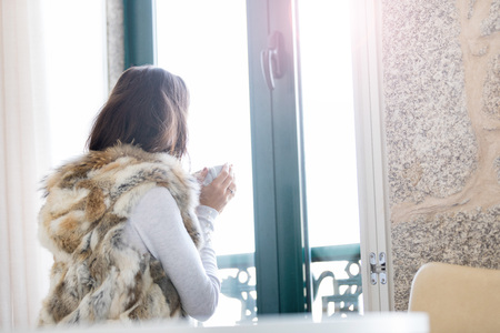 Woman relaxing at balcony enjoying sunrise. Good morningの写真素材