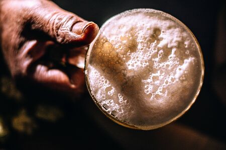 Male worker hand with beer and glass. Vintage feeling. Hipster like. With hop.の写真素材