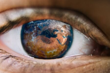 Close-up of planet earth in the ye of a child. View of a child on theの写真素材