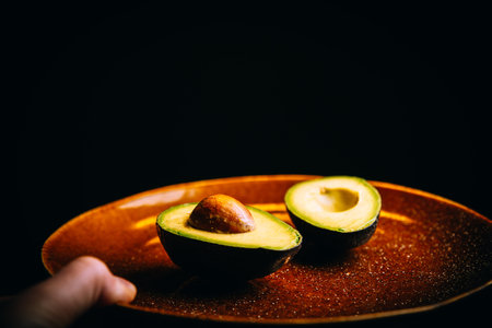 Shot of a sliced avocado on a plate. Close-up.
