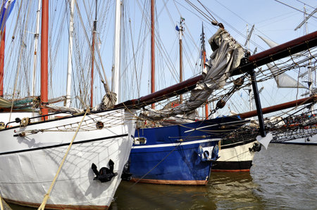 three old sail boats in the harbour in the water