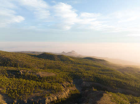 Aerial of a mountain range at sunset in Tenerife Spain, nature island, trees hills rocks, cliffs and mountains at golden hour. Europeの写真素材