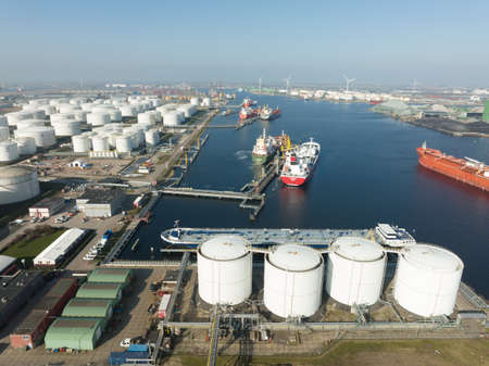 Amsterdam, 2th of March 2022, The Netherlands. Oil petrochemical storage silos and large transportation vessels in West Haven. Aerial drone view.のeditorial素材