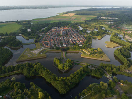 Fortified ancient old historic town of Naarden Vesting overhead aerial drone view of monumental ancient fort at the Zuiderwaterlinie medieval fortress defenisive vest landmark in The Netherlands.の写真素材