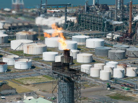 Antwerpen, 9th of August 2022, Belgium. Flaring burning of combustible exhaust gases during petroleum production. Burning combustible substances. Refinery in the port of Antwerpen.のeditorial素材