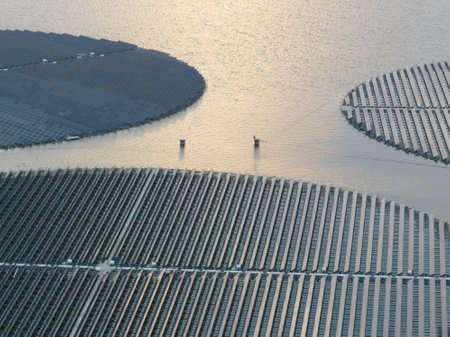Floating rotating turnable solar panels. Large scale Sustainable energy generation solar system. Green electricity power extraction from the sun on inland water pool float. The Netherlands.の写真素材