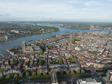 City center of Dordrecht, Dordt, South Holland, The Netherlands skyline along the Oude Maas river canal. Grote Kerk and historic traditional heritage city town. Aerial drone over view.の写真素材