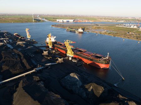 Amsterdam, 19th of November 2022, The Netherlands. Rietlanden Terminals transhipment of coal for power stations in Germany, bulk logistics storage and loading of raw energy materials. Aerial.のeditorial素材