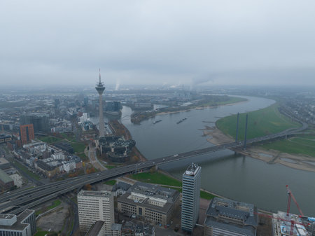 Dusseldorf , 11th of December 2022, Germany. Dusseldorf skyline city overhead view, river rhine, Rheinknie bridge, Rheinturm observation tourist attraction and broadcasting tower. Aerial drone view.のeditorial素材