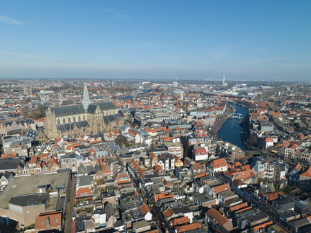 Soar above the iconic Grote Kerk, capturing its intricate spire and stunning architectural details.の写真素材