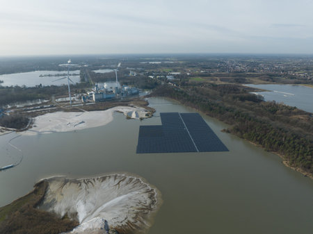 Aerial drone view on solar panels on water. Quarry and sand extraction. Sustainable innovations.