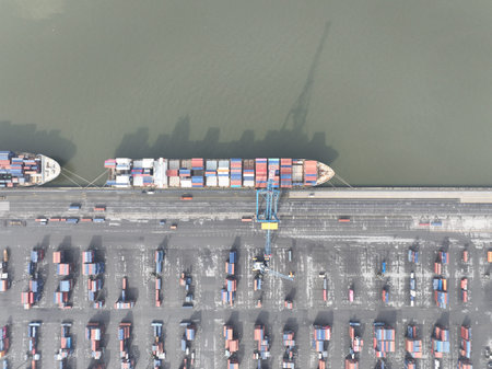 Aerial top down of container shipping, port of Antwerp, Belgium. Dock with ships and containers....
