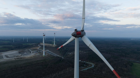 Wind turbine, renewable sustainable energy in Germany. Sunset aerial view. Green electricity from...
