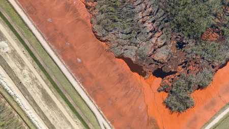 Red mud, bauxite residue, is an industrial waste generated during the processing of bauxite into alumina using the Bayer process.various oxide compounds, including the iron oxides which give its red colour.の写真素材