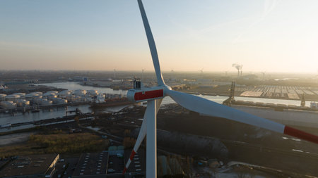 wind turbine in the port of Amsterdam, showcasing heavy industry, transport over water and renewable...
