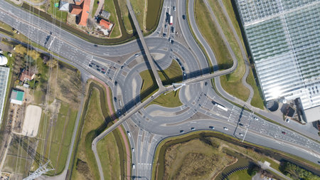 Aerial view of complex road roundabout interchange with trafficの写真素材