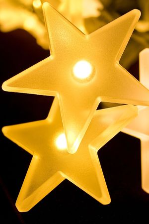 Christmas lights decoration closeup in isolated background blackの写真素材